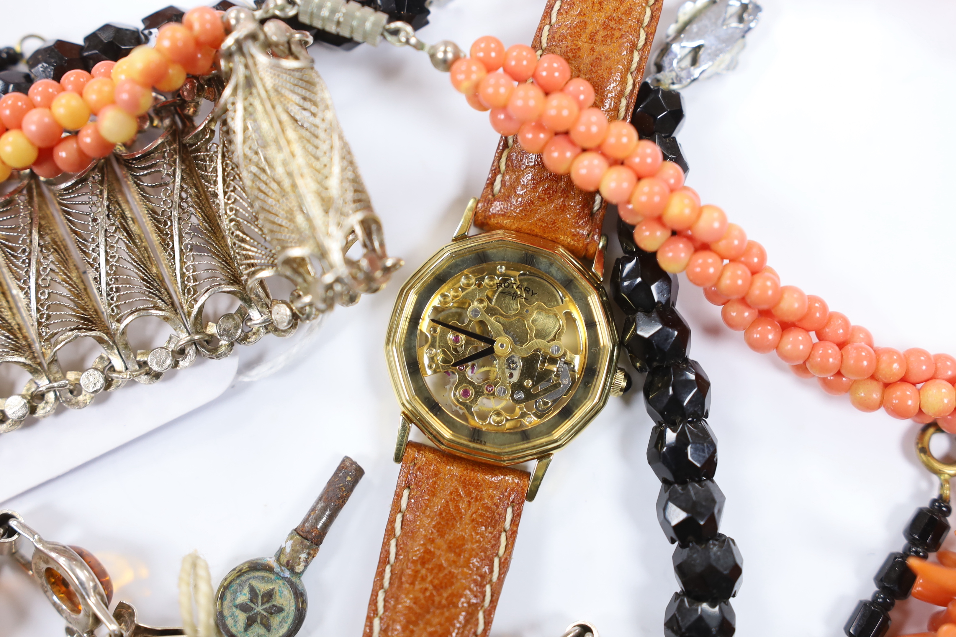 A continental 835 filigree white metal bracelet, a 925 and amber bracelet and other items including a wrist watch and a coral branch necklace.